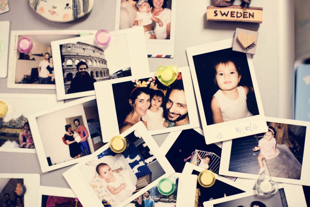 fridge covered in polaroid of family and friends