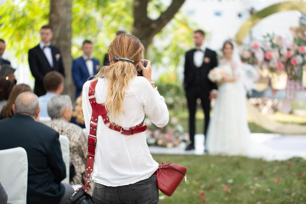 wedding photographer taking photo of bride and groom